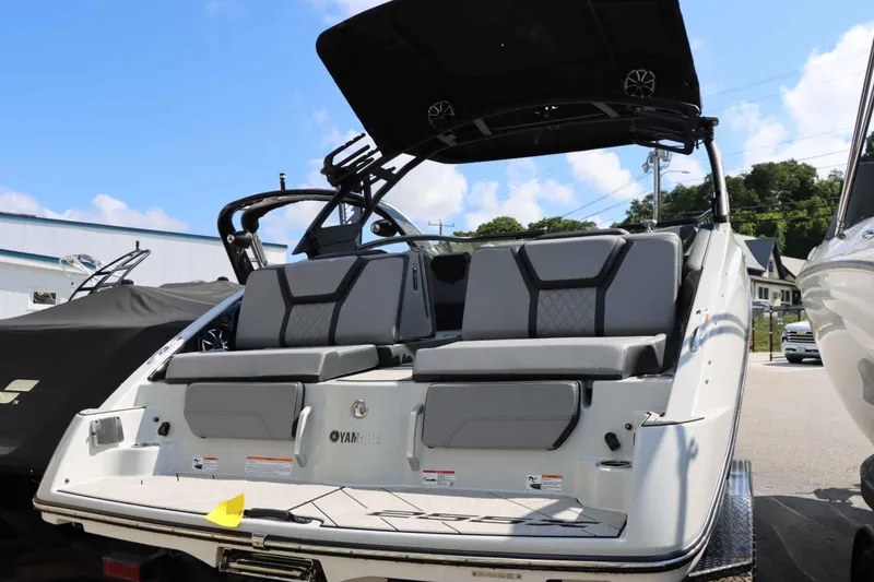 Slide: The Image of 2024 Yamaha Boats 255XE, rear view, showcasing sleek design and comfortable seating. - 17