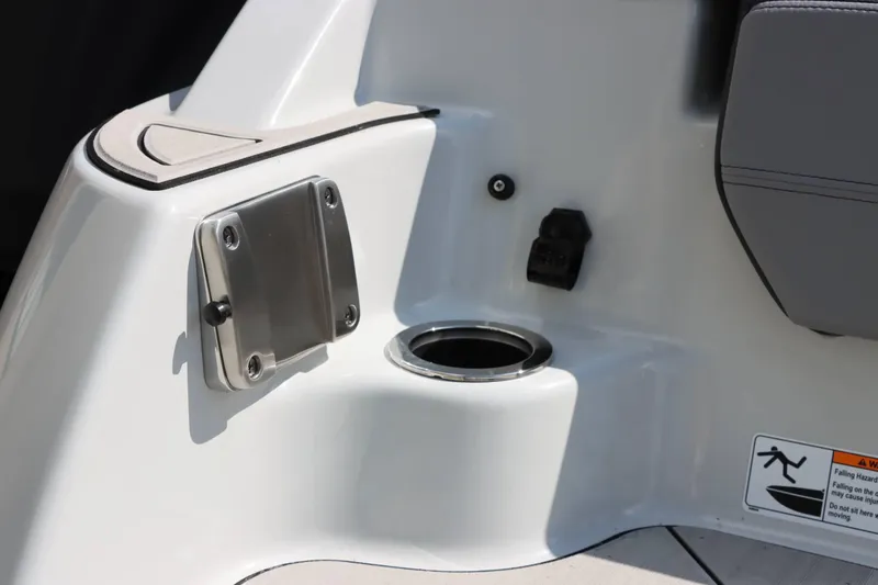 Slide: The Image of 2024 Yamaha Boats 255XE interior detail with cup holder and safety warning. - 20