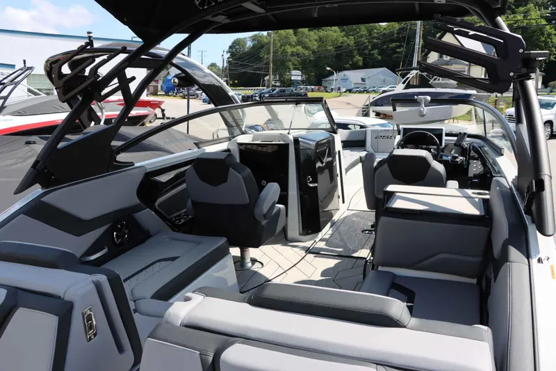 Slide: The Image of 2024 Yamaha Boats 255XE interior, featuring sleek seating and modern dashboard design. - 24