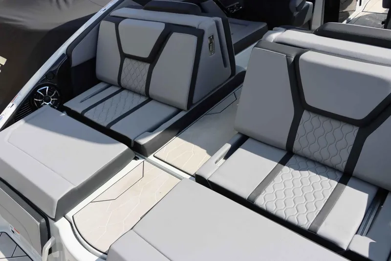 Slide: The Image of 2024 Yamaha Boats 255XE interior with modern, cushioned seating and sleek design. - 25