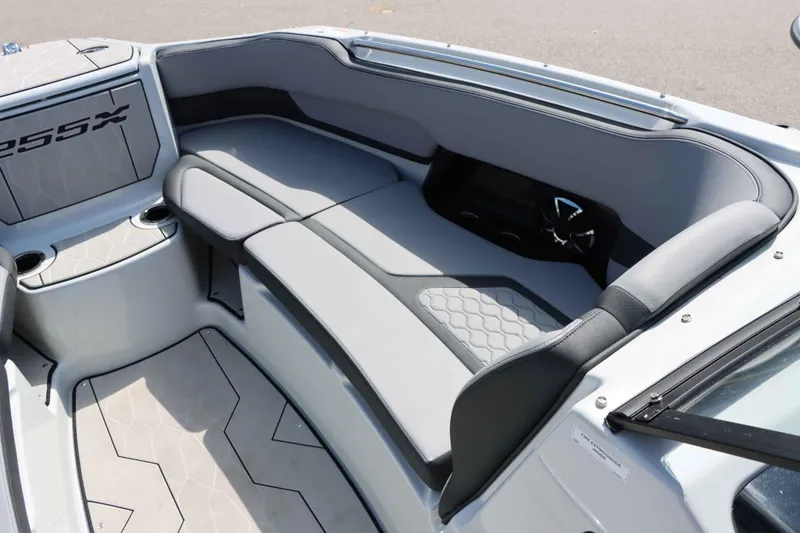 Slide: The Image of 2024 Yamaha Boats 255XE interior seating with modern design and cup holders. - 35