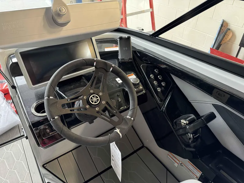 Slide: The Image of 2024 Yamaha Boats 255XE helm with steering wheel, touchscreen display, and control panel. - 5