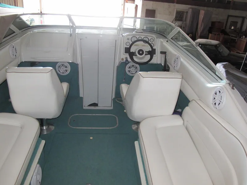 Slide: The Image of 1992 Chris-Craft 228 Concept Cuddy interior with white seating and teal carpet. - 5