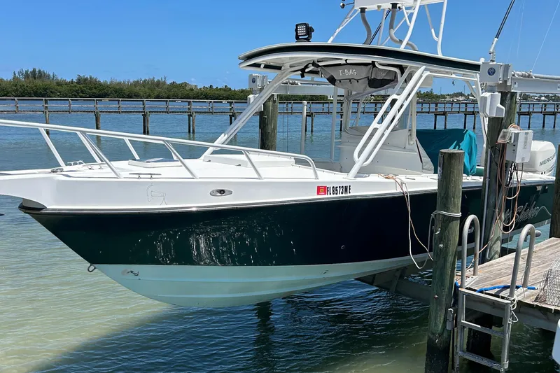 The Image of Salt Shaker Custom Edition 30 boat docked, 2003 model, white and green hull, sunny day. - 0