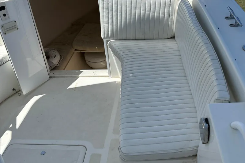 Slide: The Image of 2003 Salt Shaker Custom Edition 30 boat interior with white cushioned seating. - 18