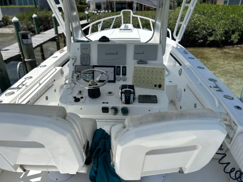 Slide: The Image of Salt Shaker Custom Edition 30 boat cockpit, 2003 model, featuring dual Garmin displays and control panel. - 5