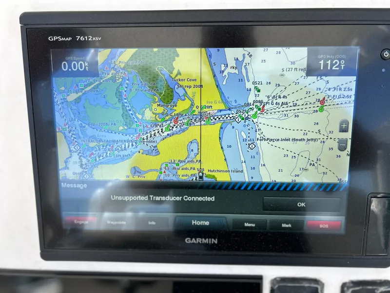 Slide: The Image of Garmin GPSmap 7612xsv displaying a nautical chart with an unsupported transducer connected message. - 9