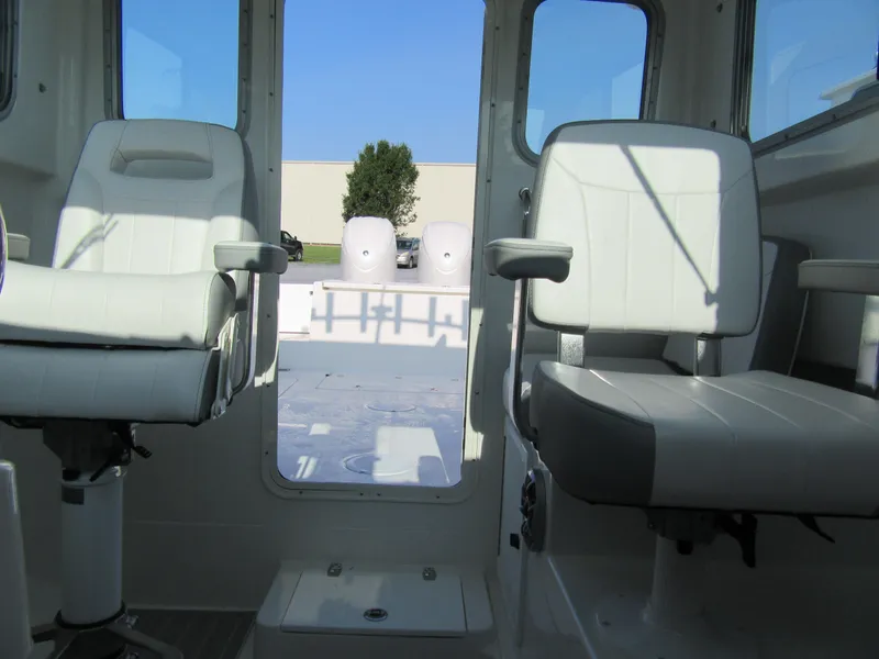 Slide: The Image of 2025 Parker 2420 Sport Cabin interior with two white seats and rear view. - 10