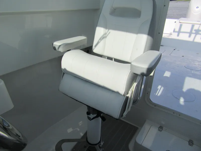 Slide: The Image of Captain's chair in 2025 Parker 2420 Sport Cabin boat interior. - 11