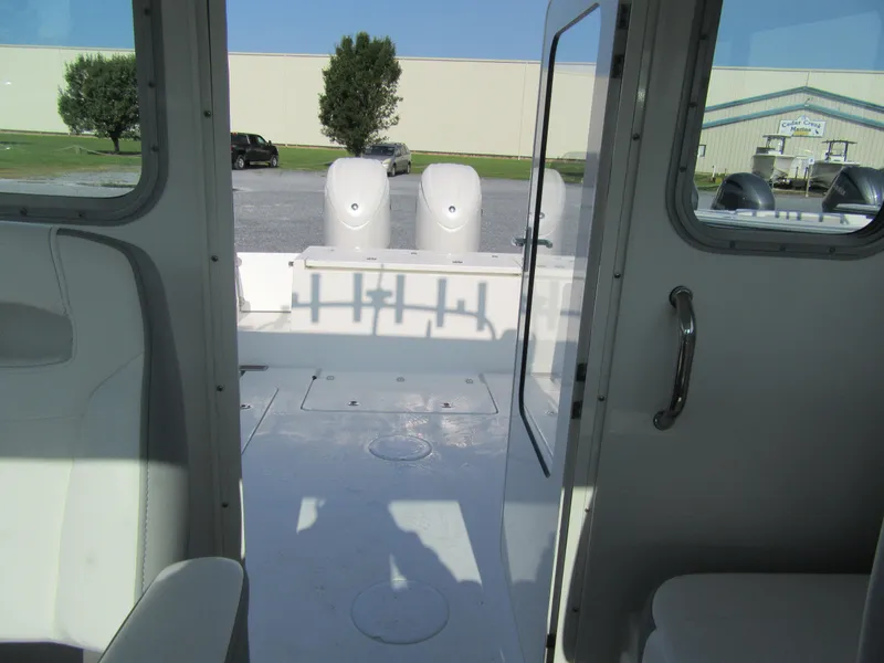 Slide: The Image of Interior view of 2025 Parker 2420 Sport Cabin boat, showcasing seating and deck area. - 12