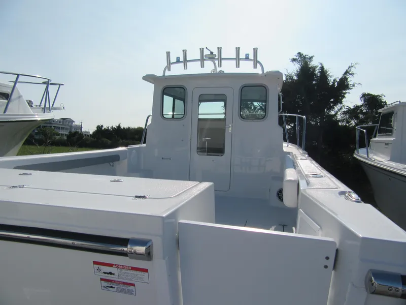 Slide: The Image of 2025 Parker 2420 Sport Cabin boat with spacious deck and modern design. - 5