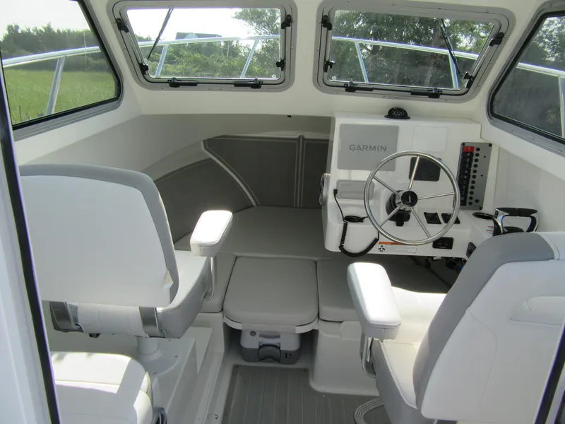 Slide: The Image of 2025 Parker 2420 Sport Cabin interior with steering wheel and seating. - 7
