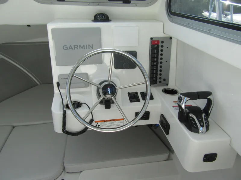 Slide: The Image of 2025 Parker 2420 Sport Cabin helm with Garmin navigation and control panel. - 8