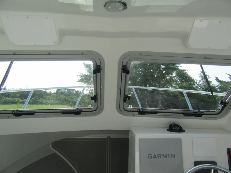 Slide: The Image of Interior view of 2025 Parker 2420 Sport Cabin boat with Garmin navigation system. - 9
