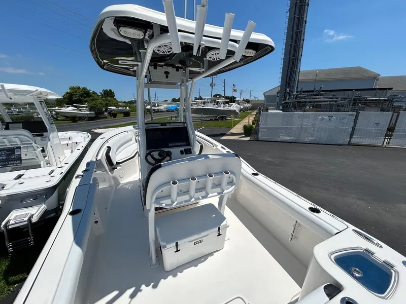 Slide: The Image of 2019 Tidewater 232 CC Adventure center console boat with T-top and fishing rod holders. - 13