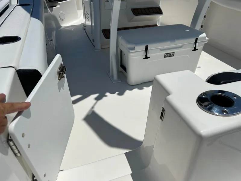 Slide: The Image of 2019 Tidewater 232 CC Adventure boat interior with Yeti cooler and storage compartments. - 15