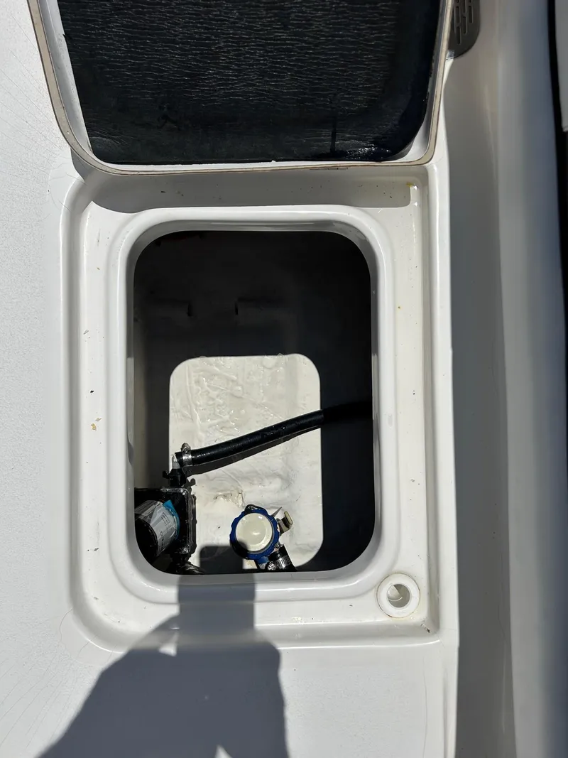 Slide: The Image of Open storage compartment on a 2019 Tidewater 232 CC Adventure boat. - 19