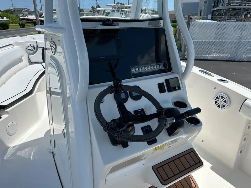 Slide: The Image of 2019 Tidewater 232 CC Adventure boat console with steering wheel and electronics. - 21