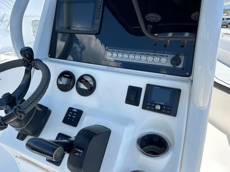Slide: The Image of 2019 Tidewater 232 CC Adventure boat console with navigation and control instruments. - 23