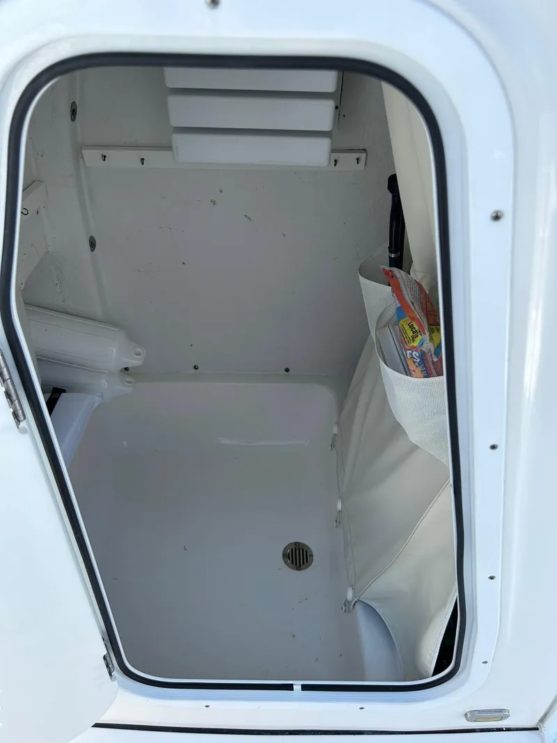 Slide: The Image of 2019 Tidewater 232 CC Adventure storage compartment with drain and side pocket. - 26