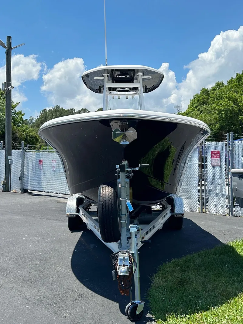 Slide: The Image of 2019 Tidewater 232 CC Adventure boat on trailer, front view, outdoors. - 8