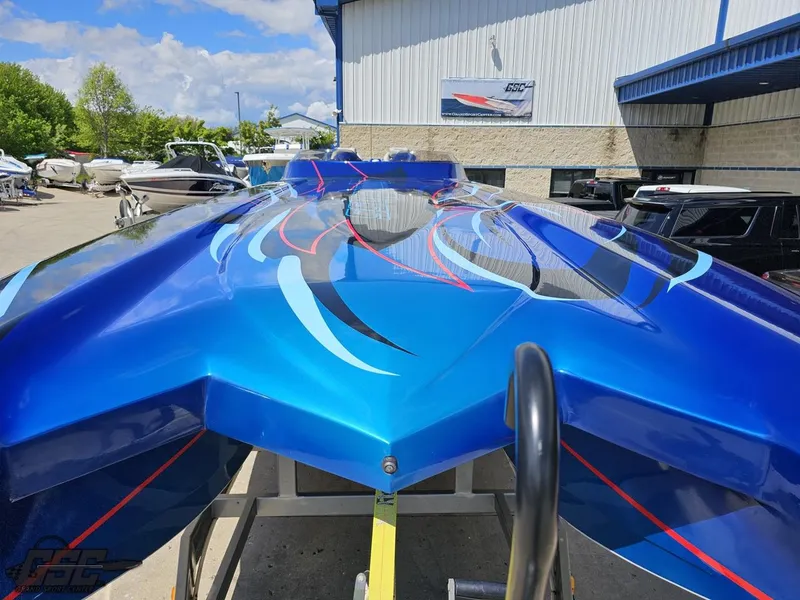 Slide: The Image of 2011 Catamaran Liquid Glass 41, vibrant blue hull with sleek graphics, docked at a marina. - 21