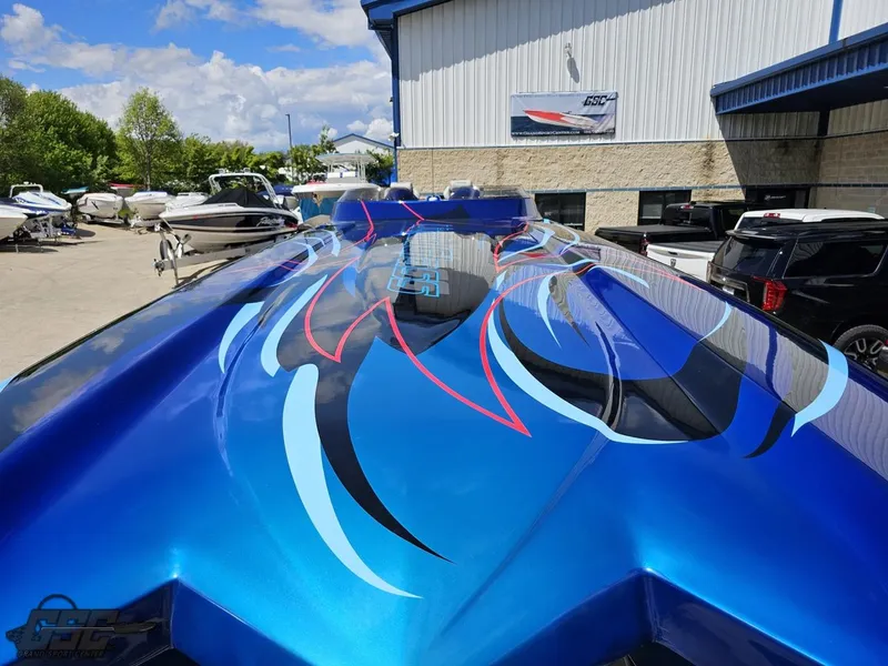 Slide: The Image of 2011 Catamaran Liquid Glass 41 with vibrant blue and black design at a boat dealership. - 22