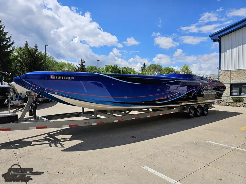Slide: The Image of 2011 Catamaran Liquid Glass 41 boat on a trailer in a parking lot. - 26