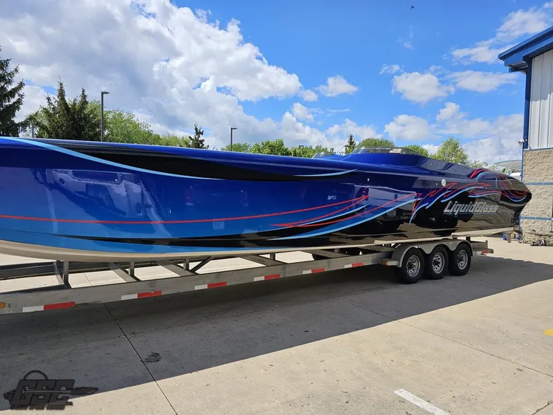 Slide: The Image of 2011 Catamaran Liquid Glass 41 on a trailer, blue and black with red accents. - 27