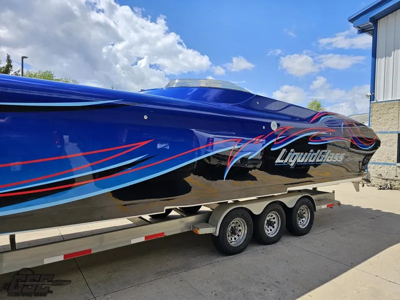 Slide: The Image of 2011 Catamaran Liquid Glass 41 on trailer, blue with red and black accents. - 29