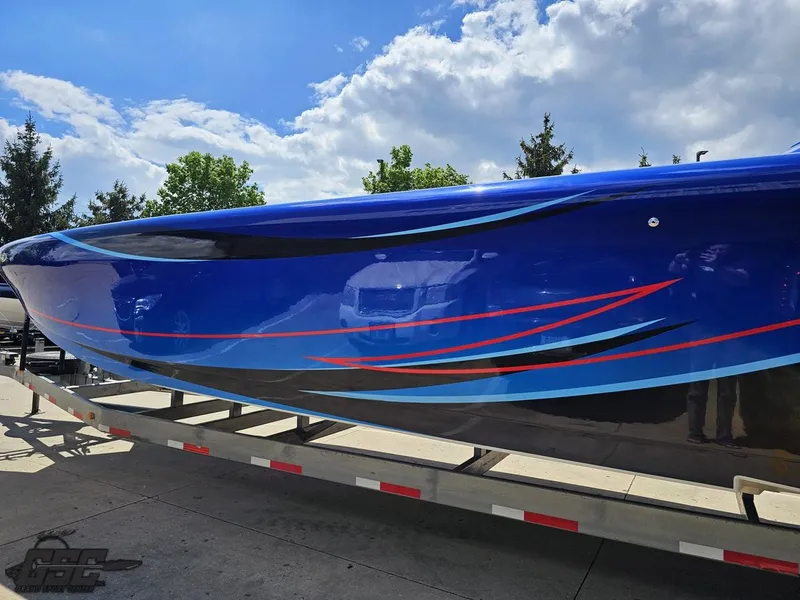 Slide: The Image of 2011 Catamaran Liquid Glass 41 on trailer, blue with red and black accents. - 36