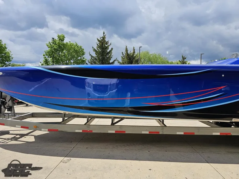 Slide: The Image of 2011 Catamaran Liquid Glass 41 on trailer, blue hull with red and black accents. - 37