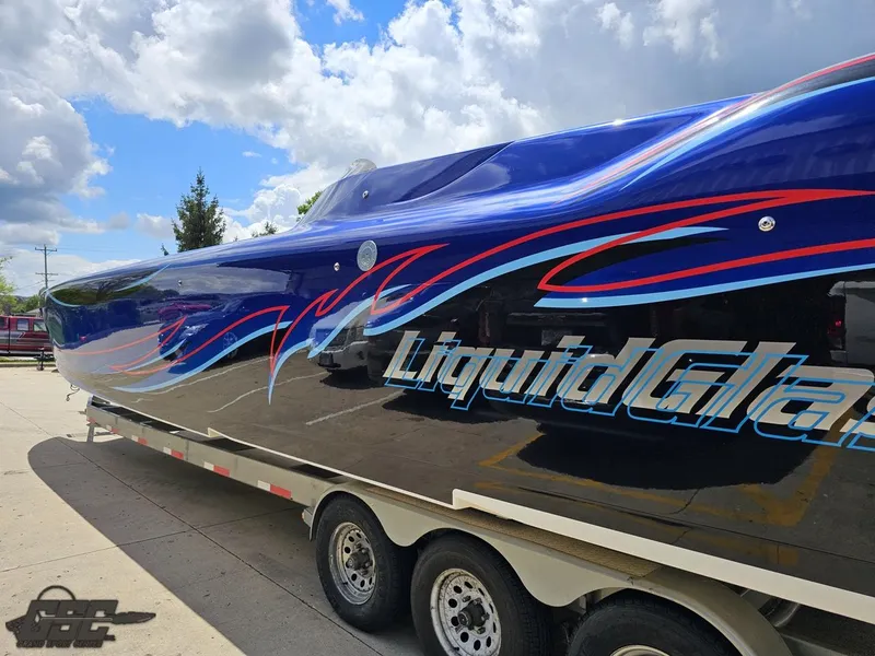 Slide: The Image of 2011 Catamaran Liquid Glass 41 boat on a trailer under a partly cloudy sky. - 39