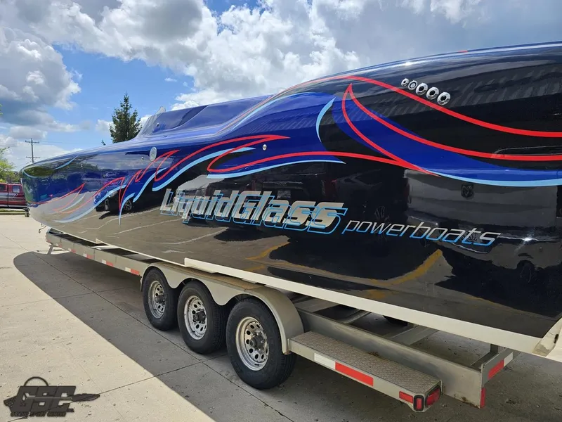Slide: The Image of 2011 Catamaran Liquid Glass 41 powerboat on a trailer, featuring vibrant blue and red graphics. - 40