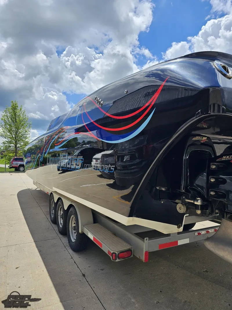 Slide: The Image of 2011 Catamaran Liquid Glass 41 on a trailer under a partly cloudy sky. - 43
