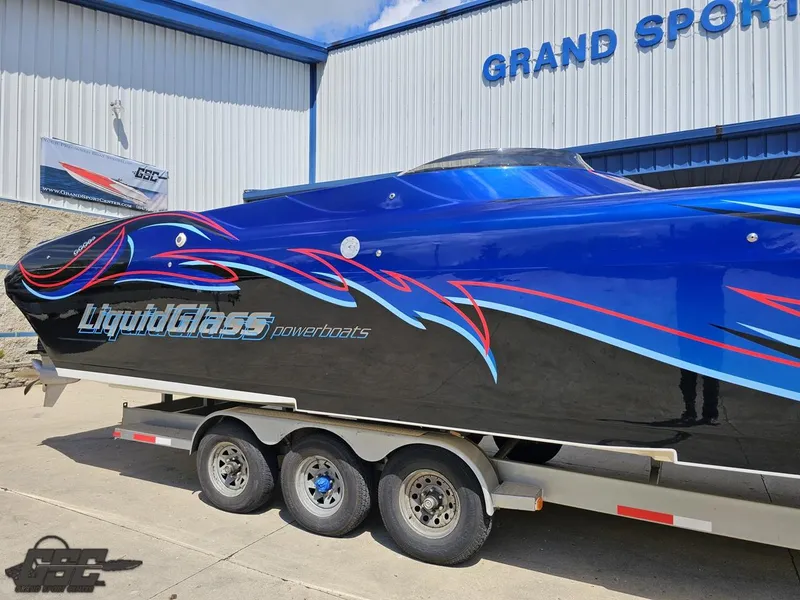 Slide: The Image of 2011 Catamaran Liquid Glass 41 powerboat on a trailer outside Grand Sport Center. - 6