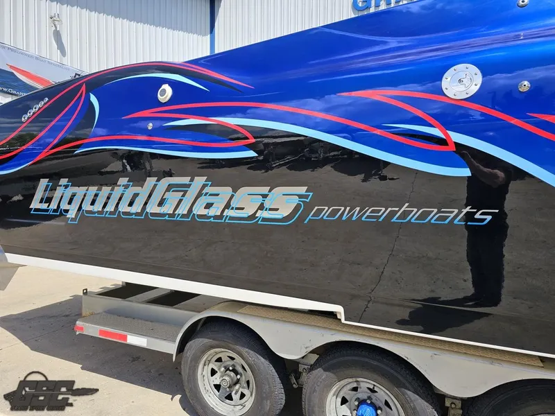 Slide: The Image of 2011 Catamaran Liquid Glass 41 powerboat on trailer with vibrant graphics. - 7