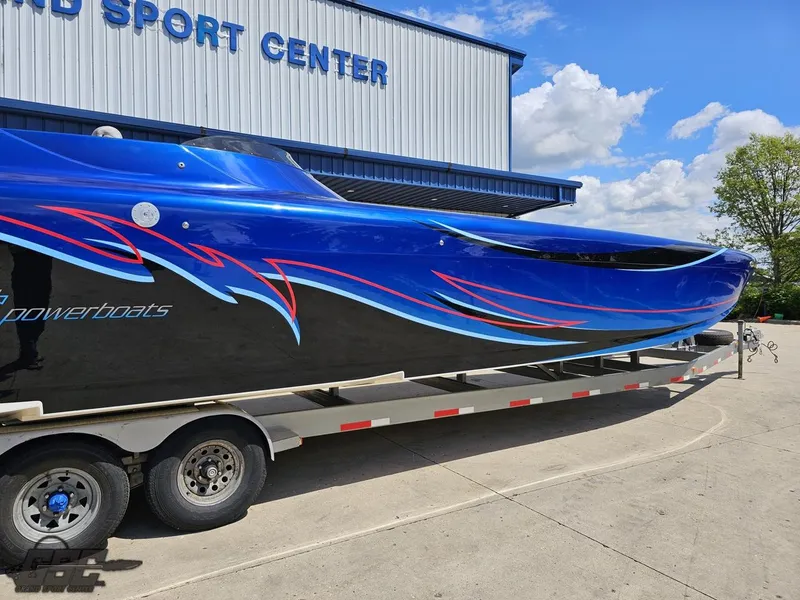 Slide: The Image of 2011 Catamaran Liquid Glass 41 powerboat on trailer outside a sport center. - 9