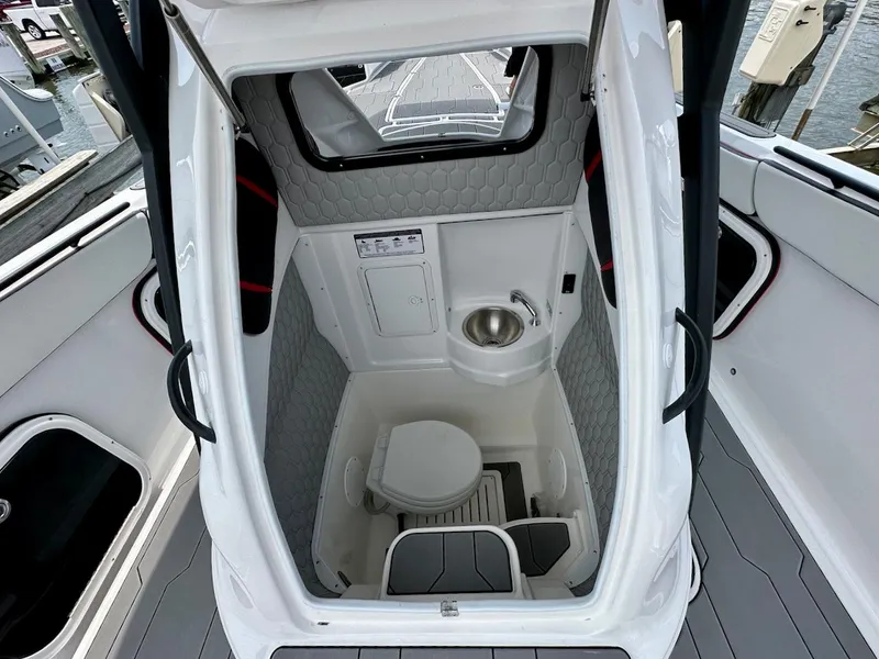 Slide: The Image of 2023 Glasstream 360 GSX Pro boat interior with compact bathroom and sink. - 16