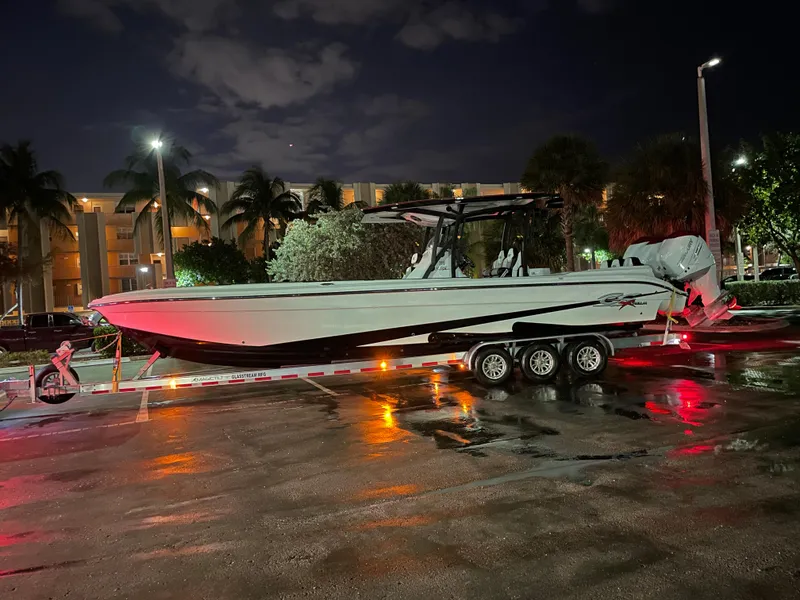 Slide: The Image of 2023 Glasstream 360 GSX Pro boat on a trailer at night, illuminated by streetlights. - 7