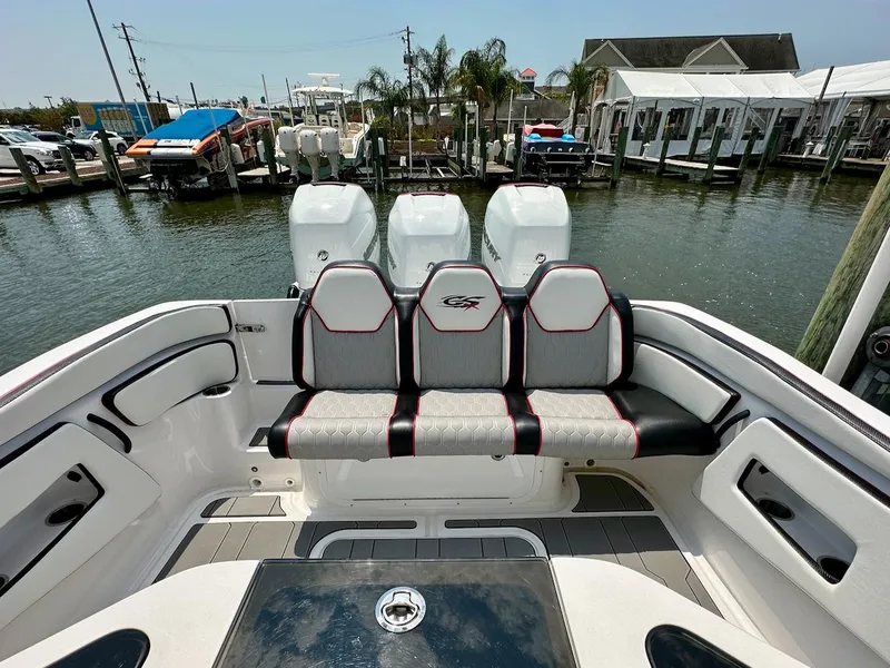 Slide: The Image of 2023 Glasstream 360 GSX Pro boat with triple outboard engines at a marina. - 9