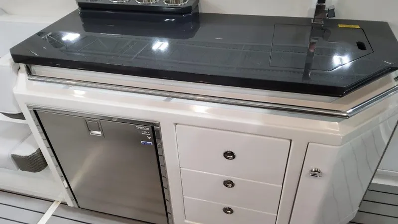 Slide: The Image of 2023 Formula 380 Super Sport Crossover OB galley with stainless steel fridge and storage drawers. - 24