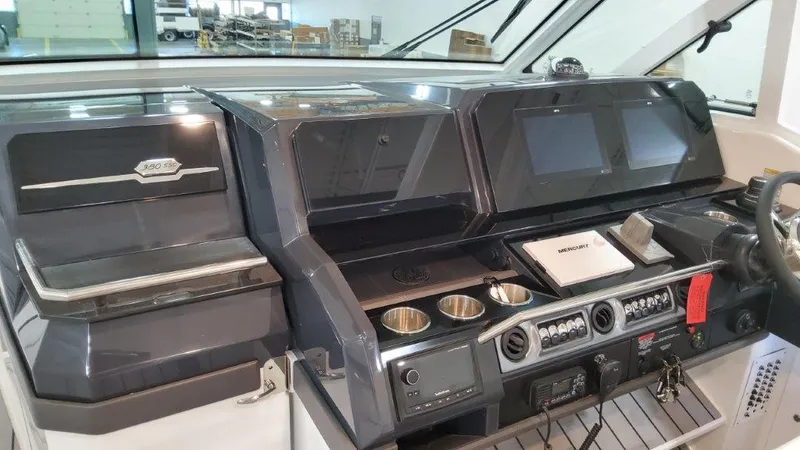 Slide: The Image of 2023 Formula 380 Super Sport Crossover OB dashboard with advanced controls and navigation screens. - 29