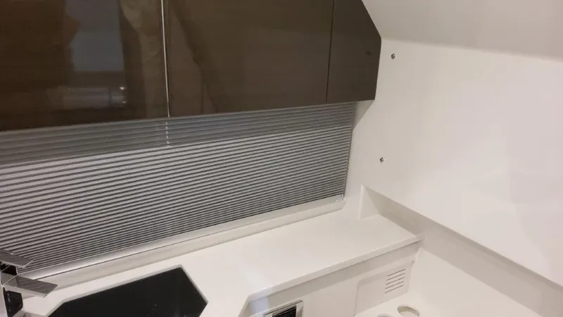 Slide: The Image of 2023 Formula 380 Super Sport Crossover OB interior kitchen area with modern cabinetry and countertop. - 31