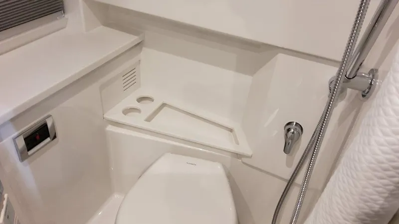 Slide: The Image of 2023 Formula 380 Super Sport Crossover OB bathroom with modern fixtures and white interior. - 32