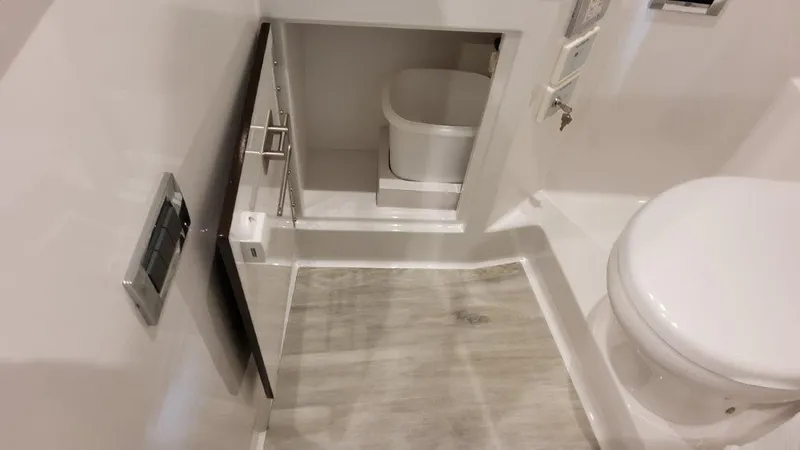Slide: The Image of 2023 Formula 380 Super Sport Crossover OB bathroom with modern fixtures and storage compartment. - 33