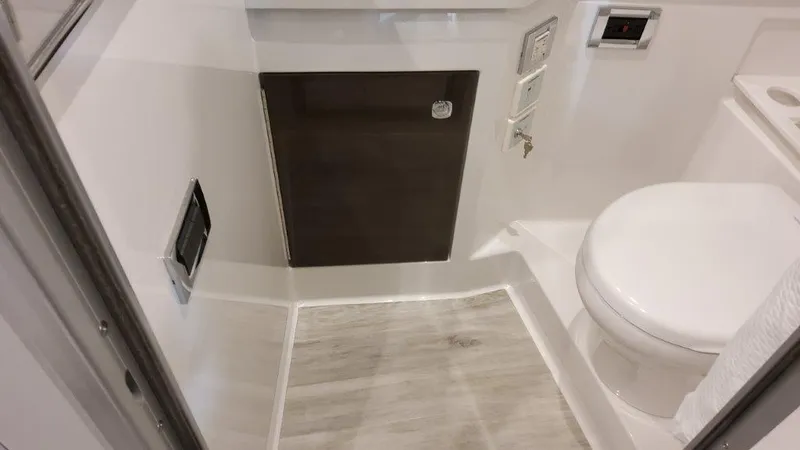Slide: The Image of 2023 Formula 380 Super Sport Crossover OB bathroom with modern fixtures and wood flooring. - 34