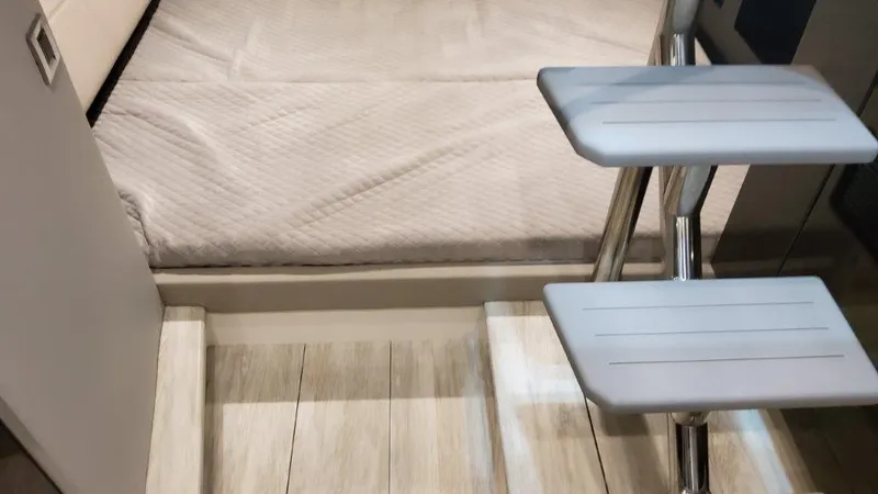 Slide: The Image of Interior cabin of 2023 Formula 380 Super Sport Crossover OB with steps leading to a bed. - 35