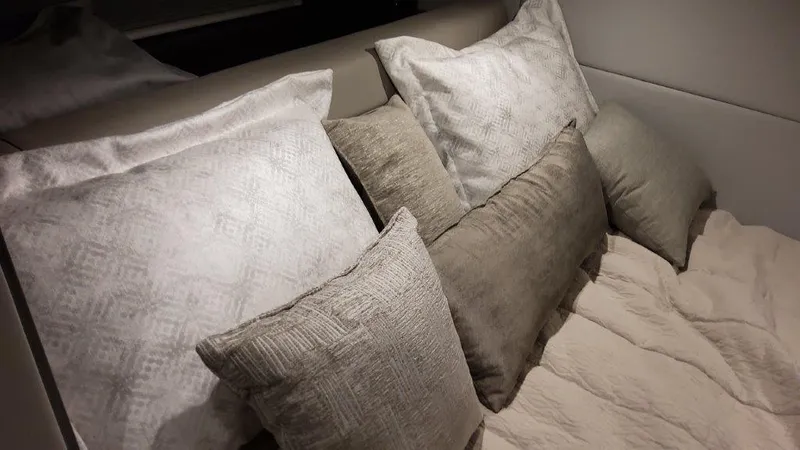 Slide: The Image of Luxurious bedding in the 2023 Formula 380 Super Sport Crossover OB cabin. - 36