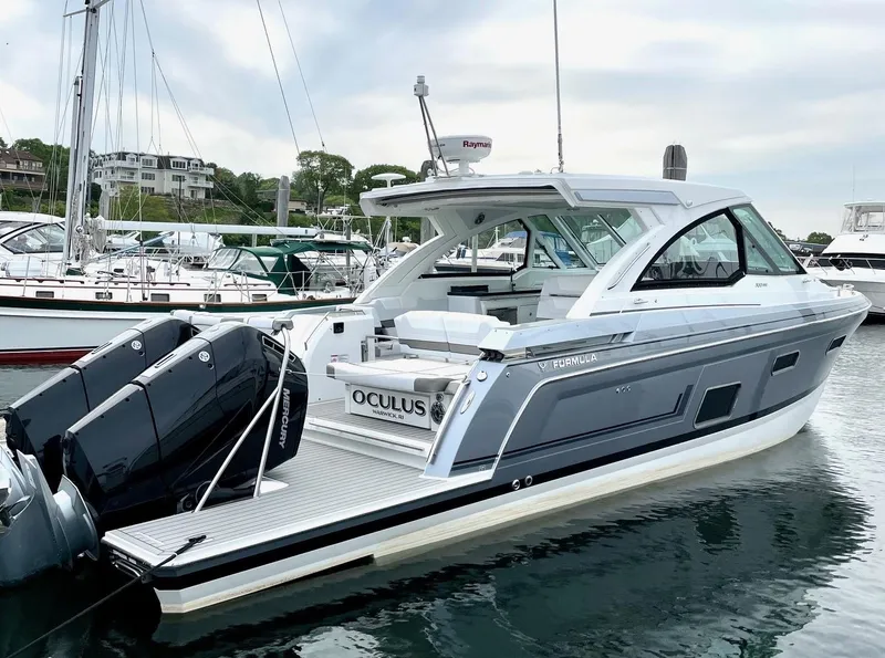 Slide: The Image of 2023 Formula 380 Super Sport Crossover OB docked at a marina. - 4